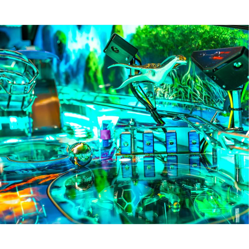 Close-up of a pinball machine with vibrant colors and reflective surface.