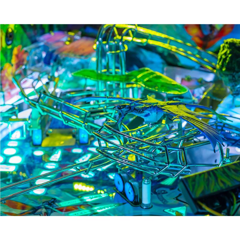 Close-up of a colorful pinball machine with vibrant neon lights.