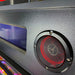 Close-up of speakers with red interior on a metallic surface