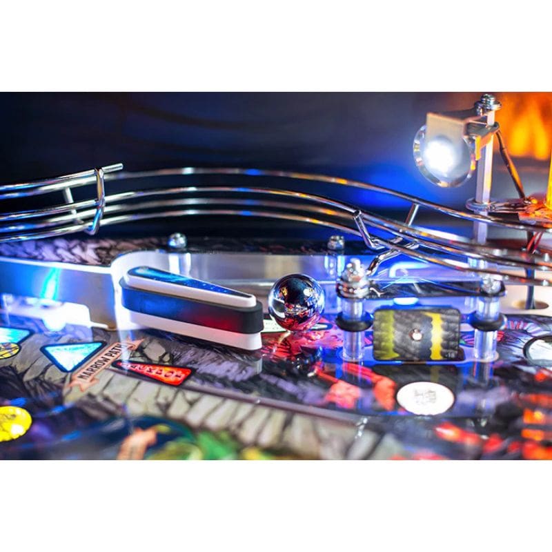 Close-up of a dungeons and dragons pinball machine with colorful playfield and lights.