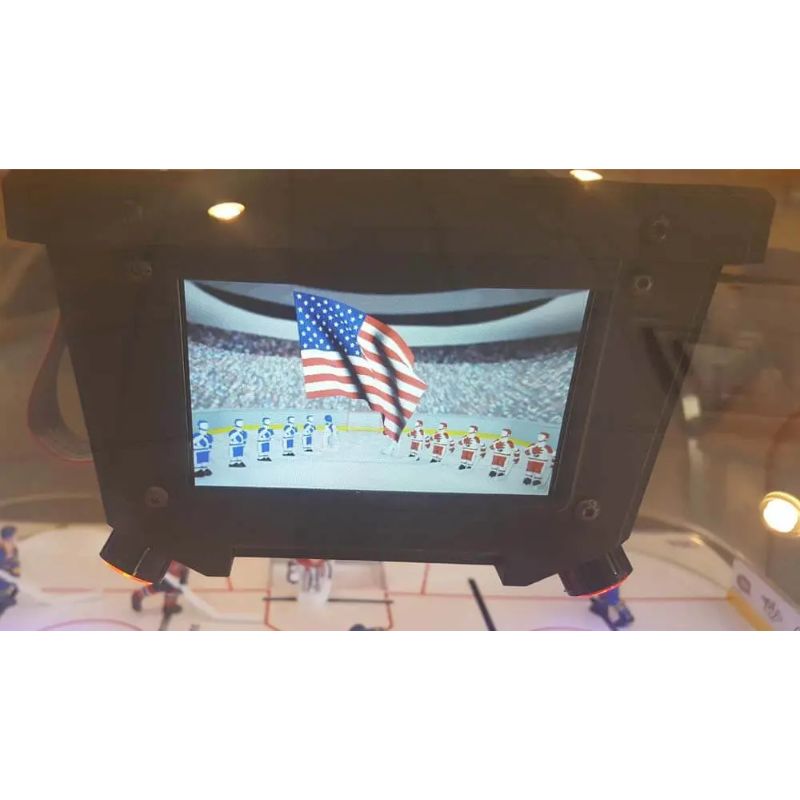 Small screen displaying a sports event with an American flag in the background