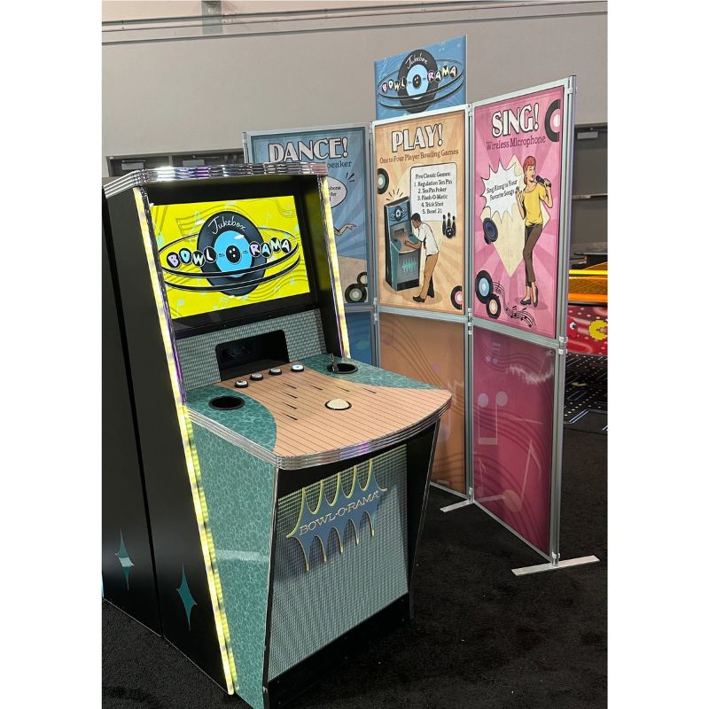 Vintage-style arcade machine with colorful posters on a gray background