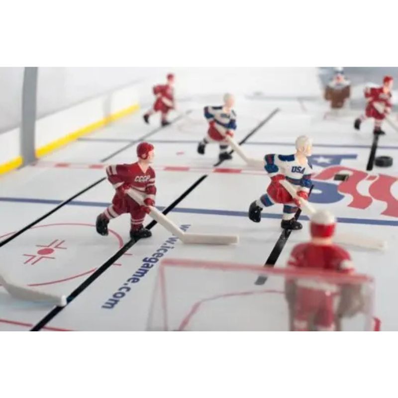 Hockey game with player figures on a miniature ice rink