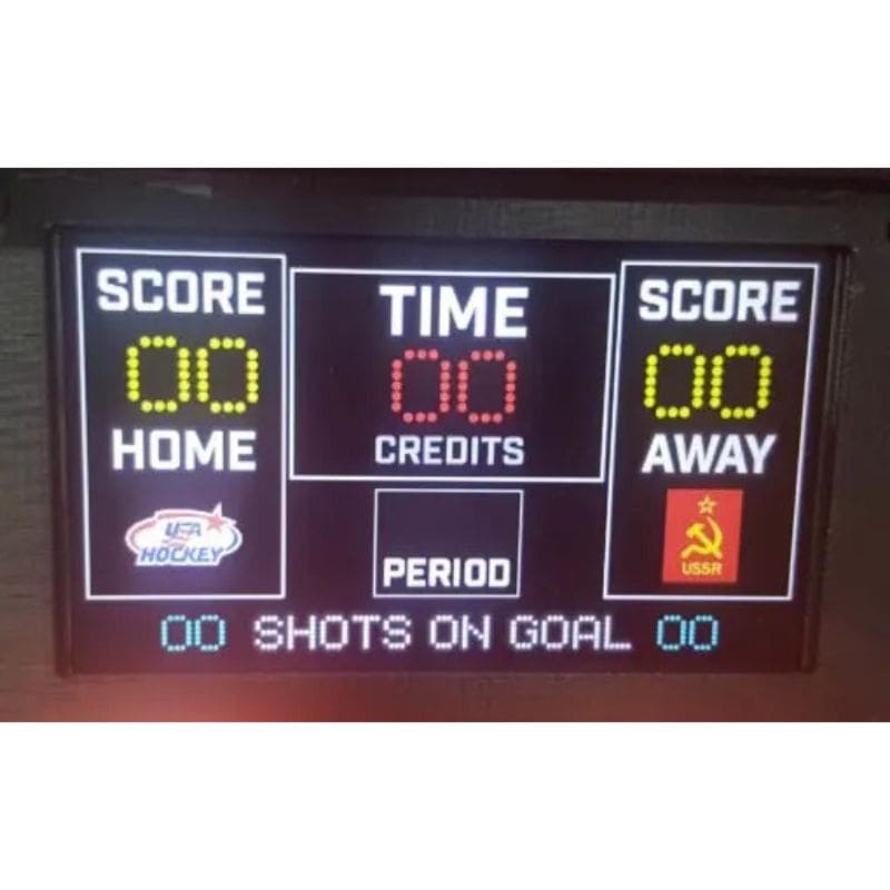 Digital scoreboard with LED display for a hockey game, featuring scores and time.