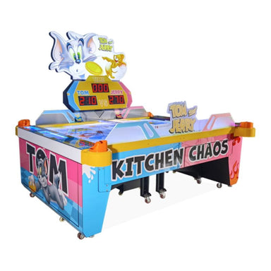Colorful air hockey table with cartoon characters and 'Tom Kitchen Chaos' text on a white background