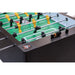 Close-up of a Tornado Classic II foosball table with green playing surface and metal rods.