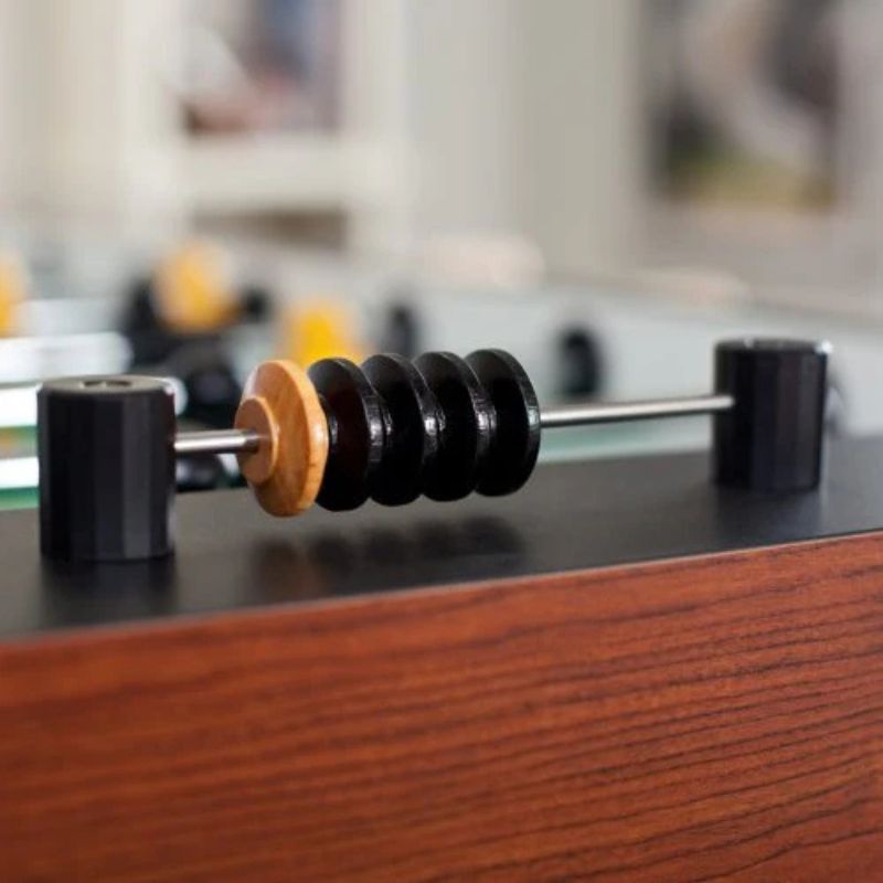 Close-up of a foosball table with a blurred background