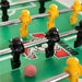 Close-up of a Tornado Elite  foosball table with players and a ball on a green surface.