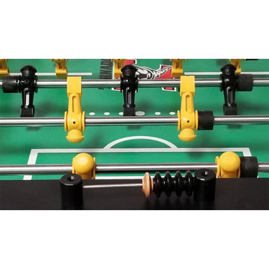 Close-up of a table football game in progress with players on the field.