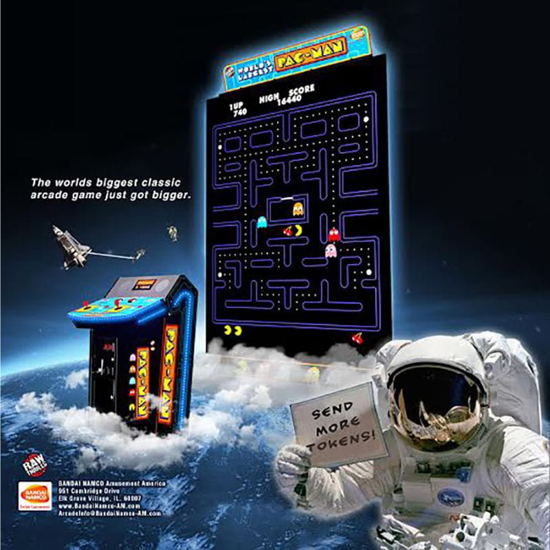 Pac-Man arcade game with astronaut holding a sign in space