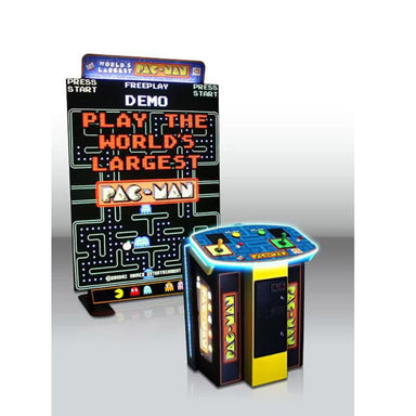 World's Largest Pac-Man arcade game with promotional sign on a white background