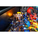 Close-up of a dungeons and dragons pinball machine with a glowing mechanism and colorful playfield.
