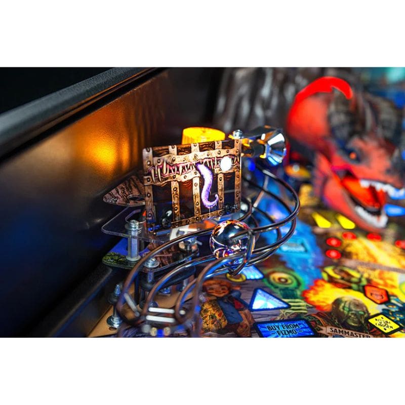 Close-up of a dungeons and dragons pinball machine with a glowing mechanism and colorful playfield.